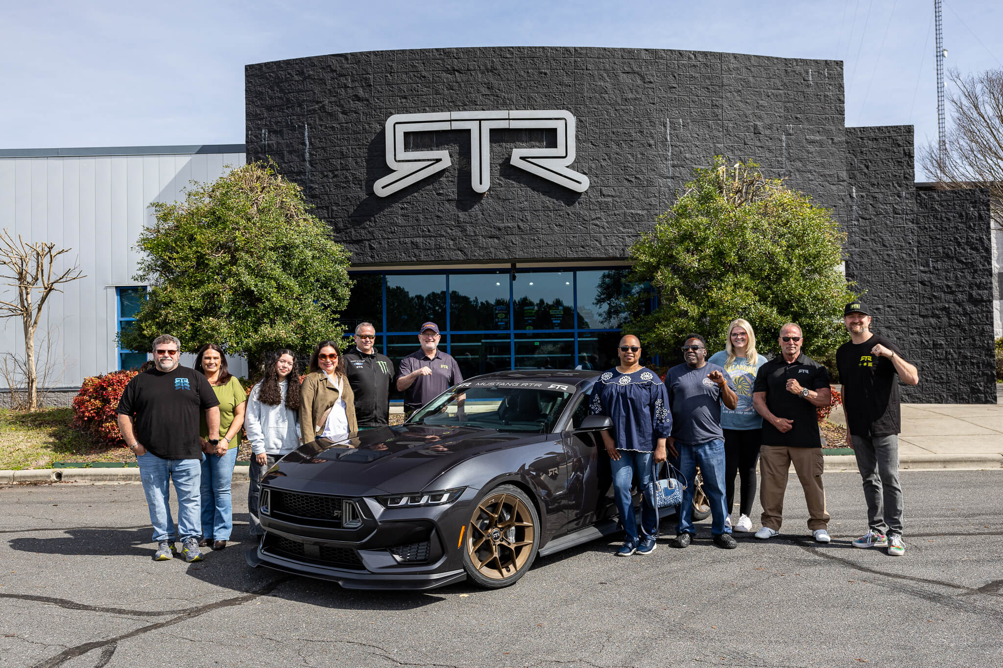 RTR owners take a photo with 2024 Mustang RTR Spec 2 and Vaughn Gittin Jr