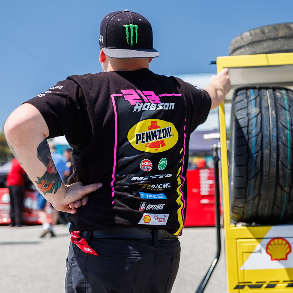 A man in the 2024 Ben Hobson Official RTR Drift Team Shirt, embodying Ben's racing spirit. Capturing the essence of his Mustang RTR Spec 5-FD design.