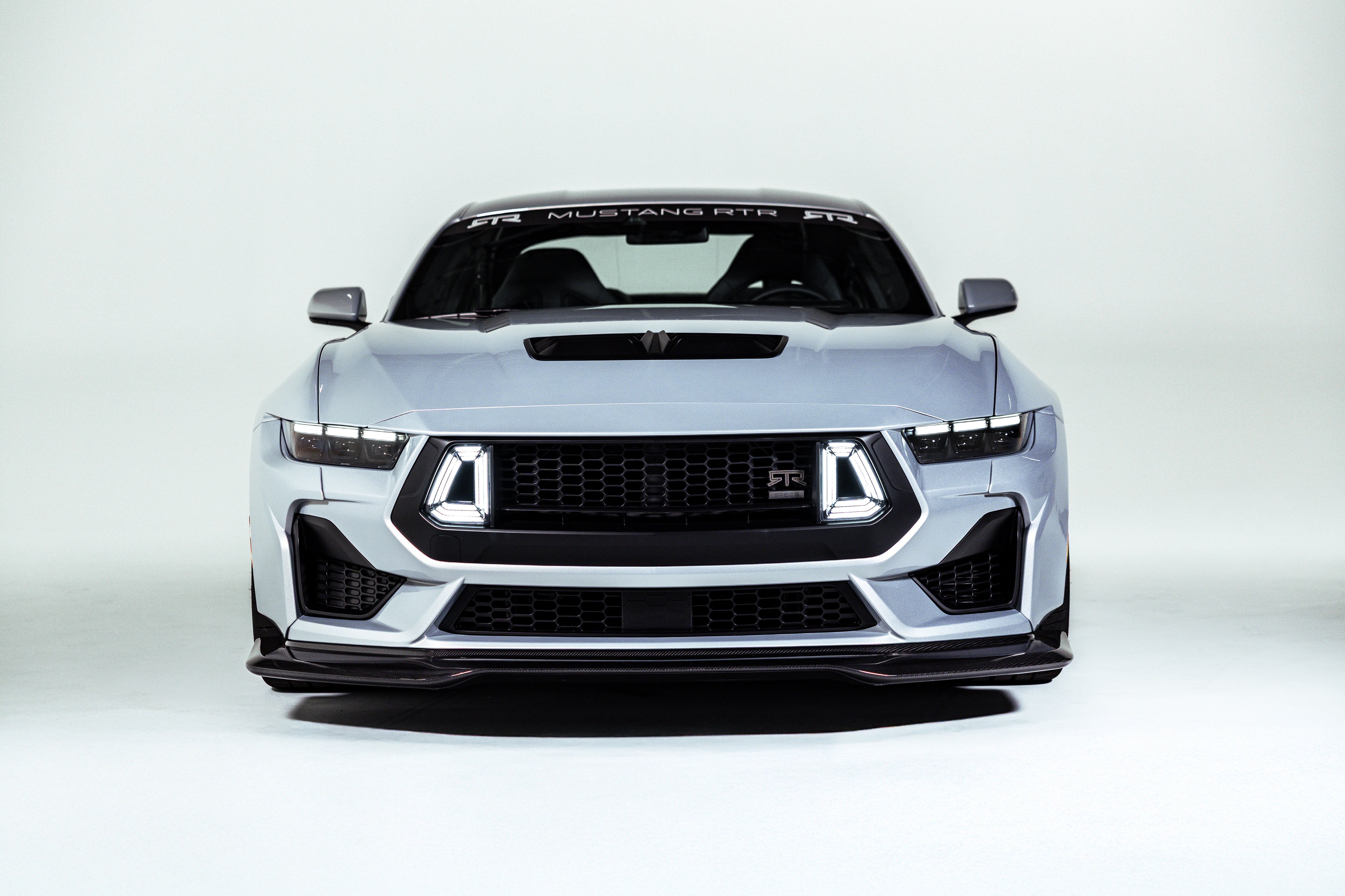 Front view of the 2026 Mustang RTR Spec 5 in studio lighting showcasing new complete widebody system and carbon fiber wake towers paired with RTR components
