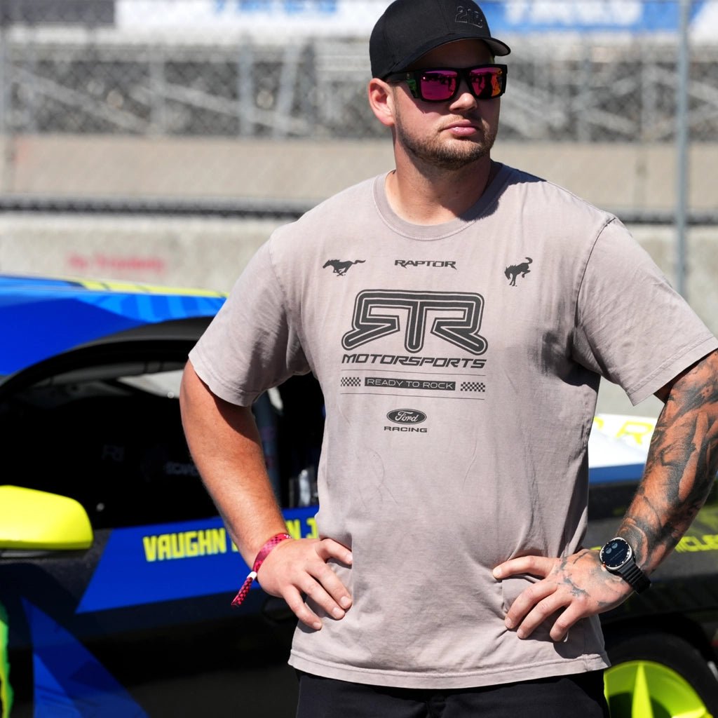 RTR Vehicles crew member wearing the Vintage Grey 2026 RTR Motorsport Collection Vintage short sleeve T-Shirt track side at Laguna Seca.