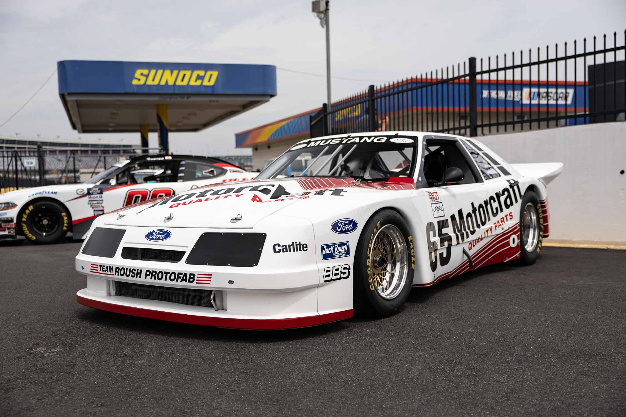 A foxbody Mustang sporting a Motorcraft livery and body kit at the Mustang 60th Anniversary