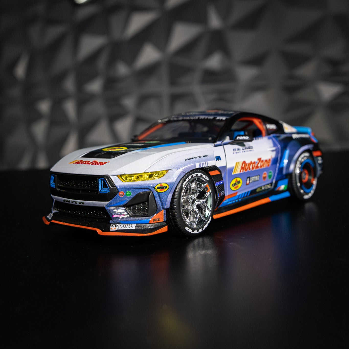 James Deane's 2024 Ford Mustang RTR Spec 5-FD Diecast Model showcasing intricate detailing, rubber tires, and opening components on a black surface.