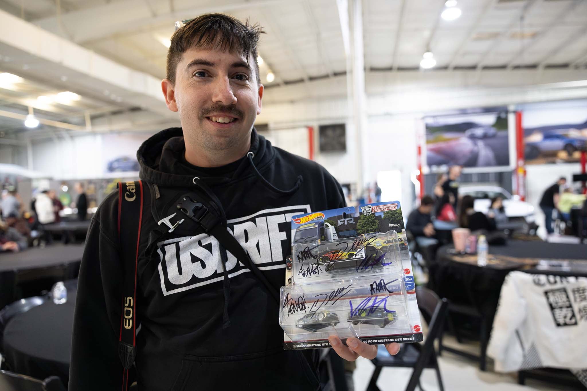A fan poses with Hot Wheels signed by all the RTR drivers