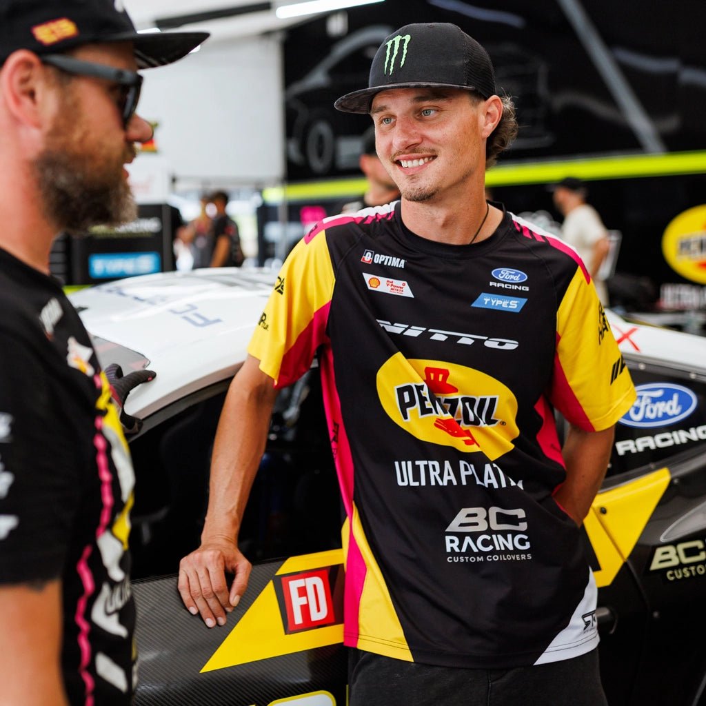 Ben Hobson talking to his crew while wearing his 2026 RTR Drift Team Sublimated Shirt at Formula Drift.