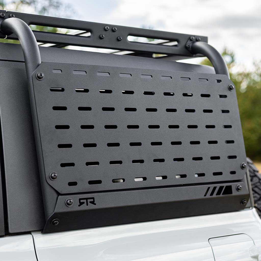 Black metal RTR Molle Accessory Panel for Ford Broncos, designed for RTR Bronco Roof Rack. Sturdy aluminum construction, textured powder coat finish, and easy installation for off-road gear accessibility.