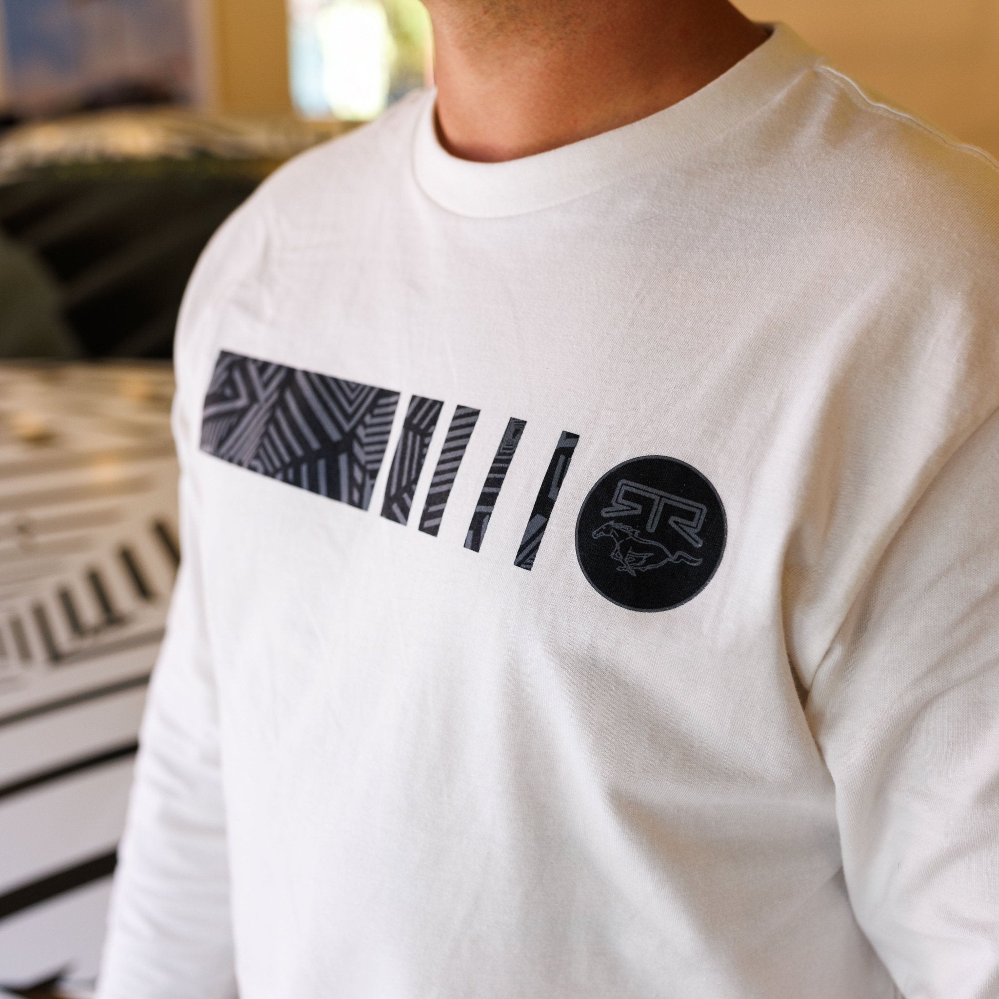 Person wearing Ford Mustang x RTR Collection Frames Long Sleeve T-Shirt, featuring black geometric vertical bars and RTR logo with galloping horse graphic on the chest.