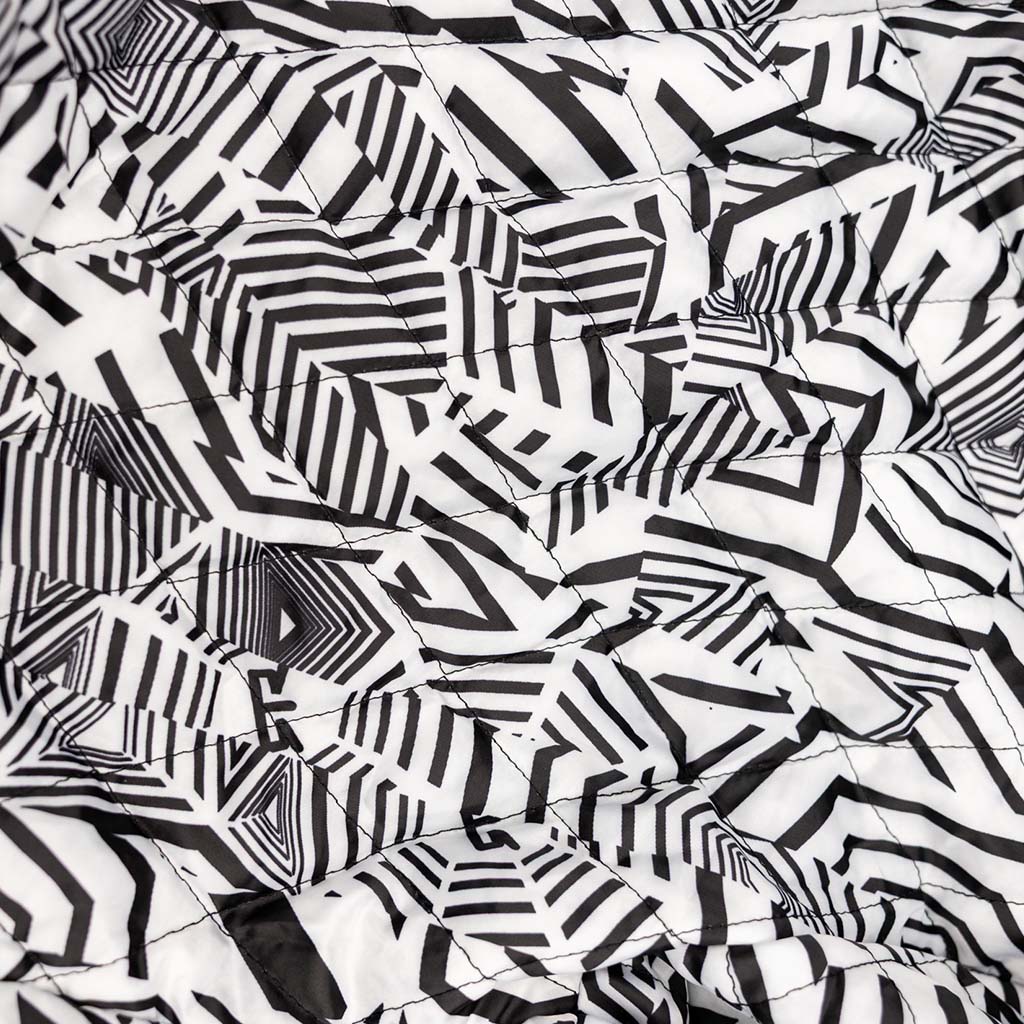 Ford Mustang x RTR Collection Stealth Jacket's quilted interior with bold black geometric pattern, showcasing its RTR dazzle camo design and meticulous stitching details.