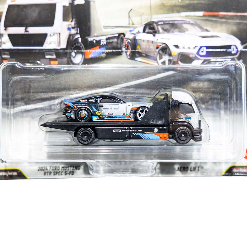 Limited Edition 1/64th scale James Deane 2024 Ford Mustang RTR Spec 5 - FD Hot Wheels with transporter diecast front close up view.