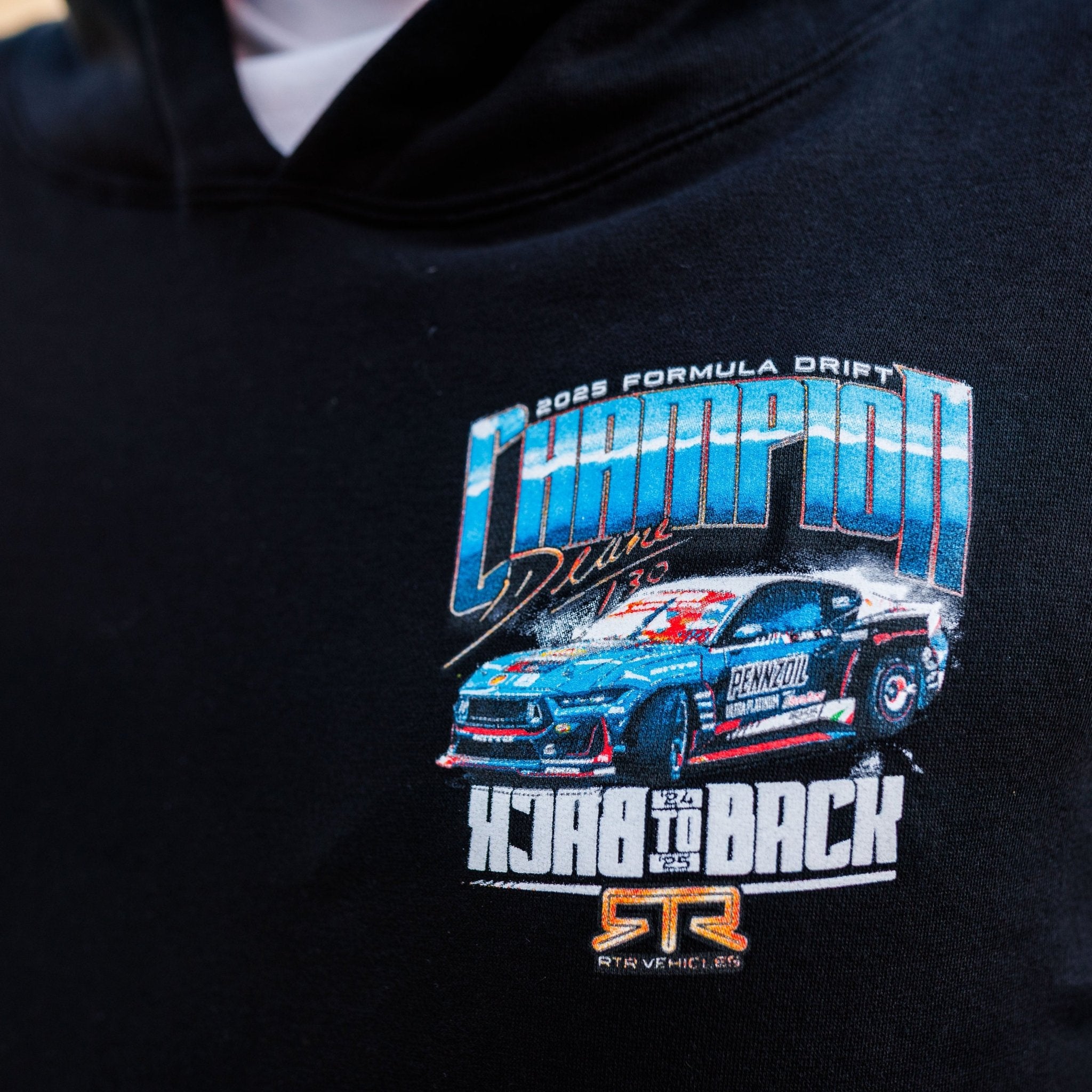 James Deane 2025 Championship Hoodie featuring a colorful graphic of a drift car, “2025 Formula Drift Champion,” and “Back to Back” text.