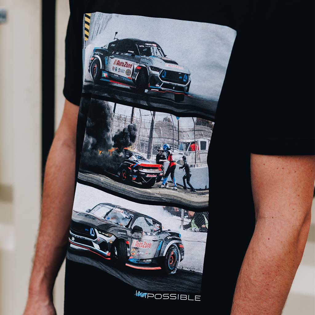 A person in a black shirt featuring James Deane's competition Mustang on track. Never Quit Tee and Poster Bundle captures James Deane's victorious Formula Drift Long Beach journey.