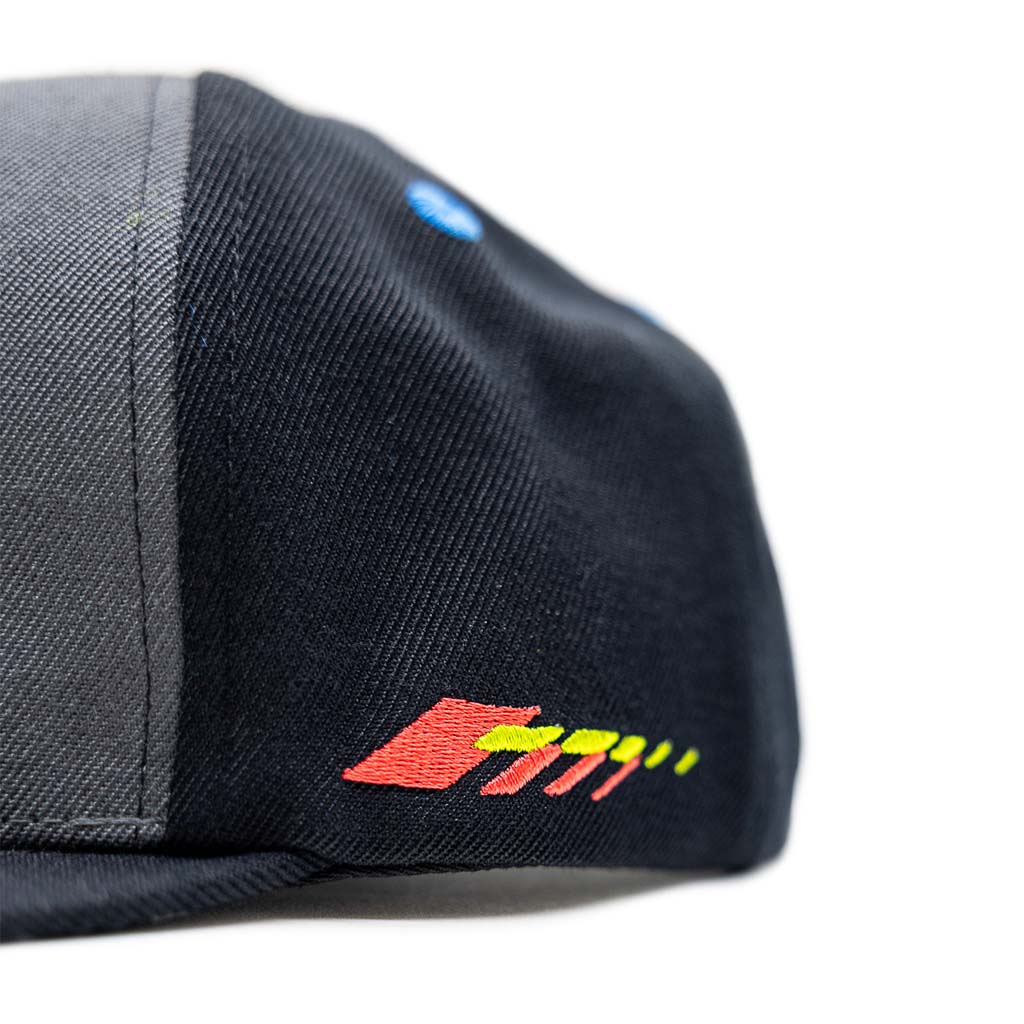 Close-up of the RTR Drift Team Snapback, featuring a structured crown, flat brim, and red-yellow logo, designed for motorsports fans with embroidered details.