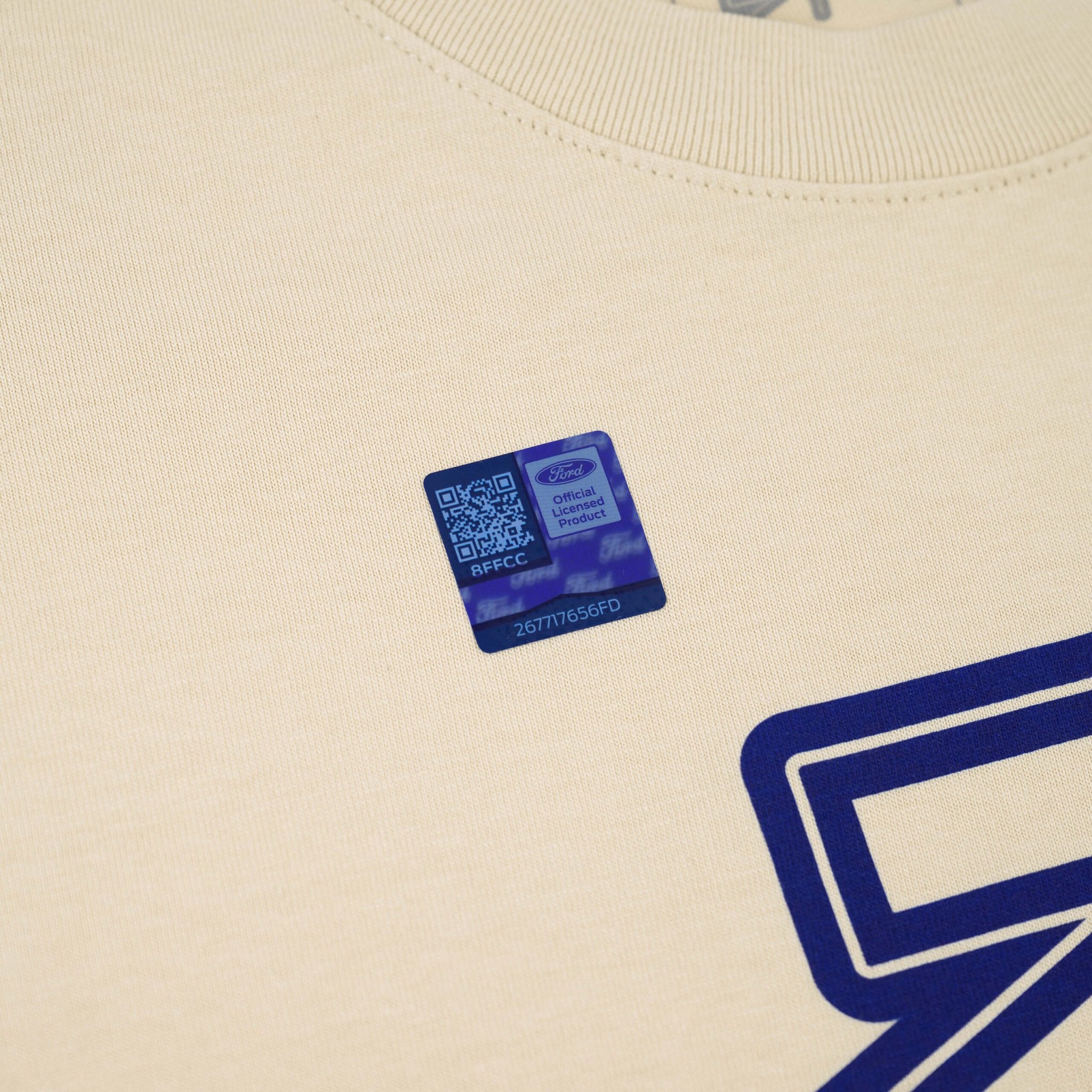 Close-up of the RTR Equipp'd T-Shirt showcasing numbers and a QR code on fabric, highlighting its connection to Mustang culture and lifestyle.
