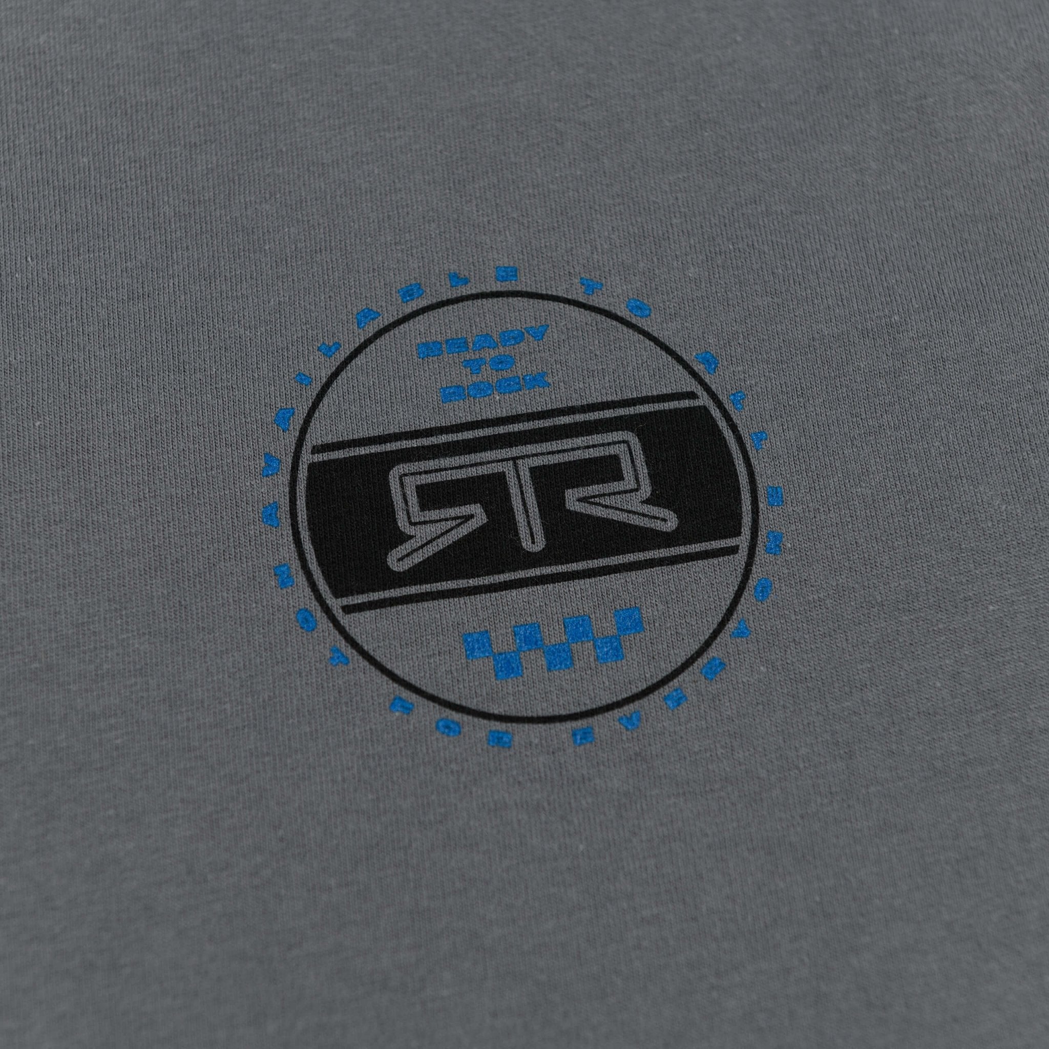 RTR Heritage Badge T-Shirt featuring a bold logo and emblem on charcoal fabric, symbolizing RTR's legacy and modern style.
