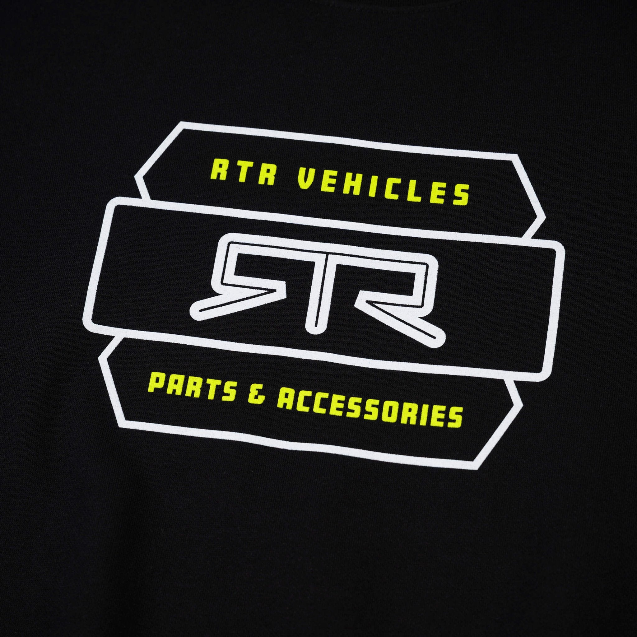 Close-up of RTR Parts & Accessories Crewneck Sweatshirt with bold RTR logo in Hyper Lime, featuring a woven label on the sleeve cuff.