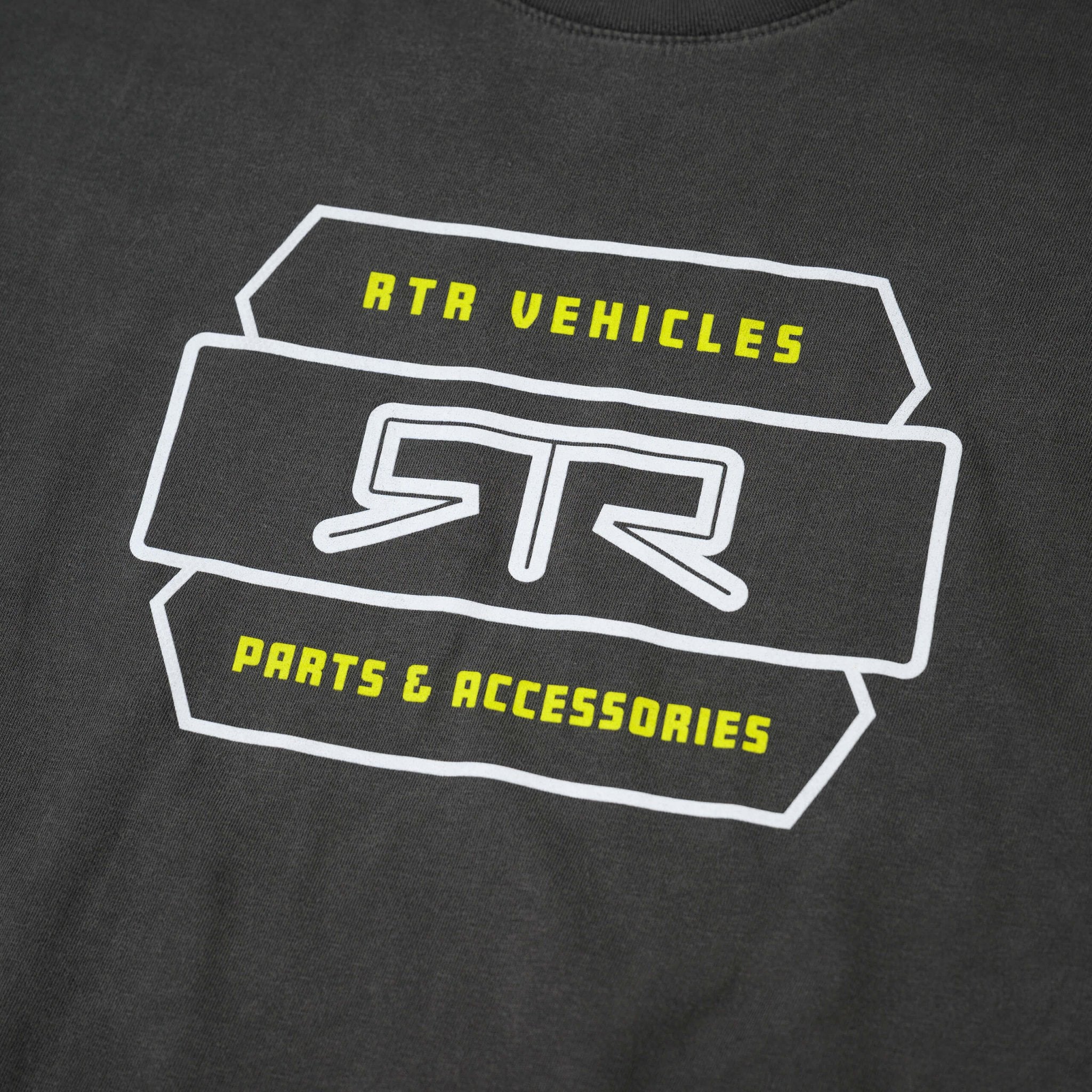 Close-up of the RTR Parts & Accessories T-Shirt, showcasing soft black fabric, bold front graphic, and woven RTR hem tag for authenticity.