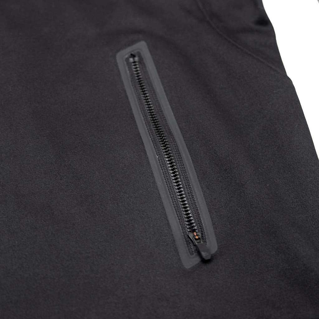 Close-up of the RTR Quarter Zip Pullover, highlighting the sleek exposed Vislon zipper on a black jacket, emphasizing its modern, sophisticated design.