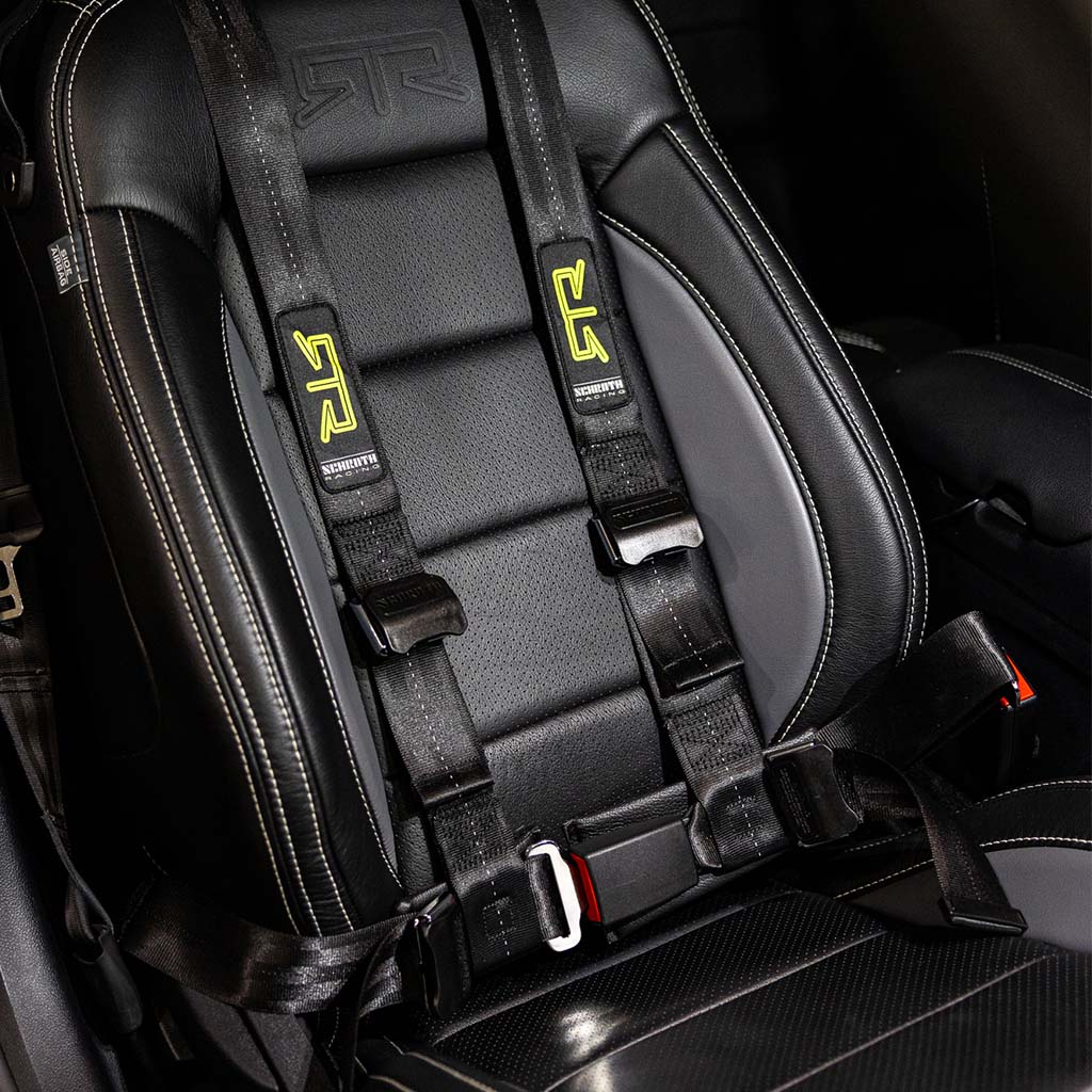 RTR QuickFit Harness for 05-24 Mustang, shown attached to a car seat with straps and factory anchor points for dual track and street use.