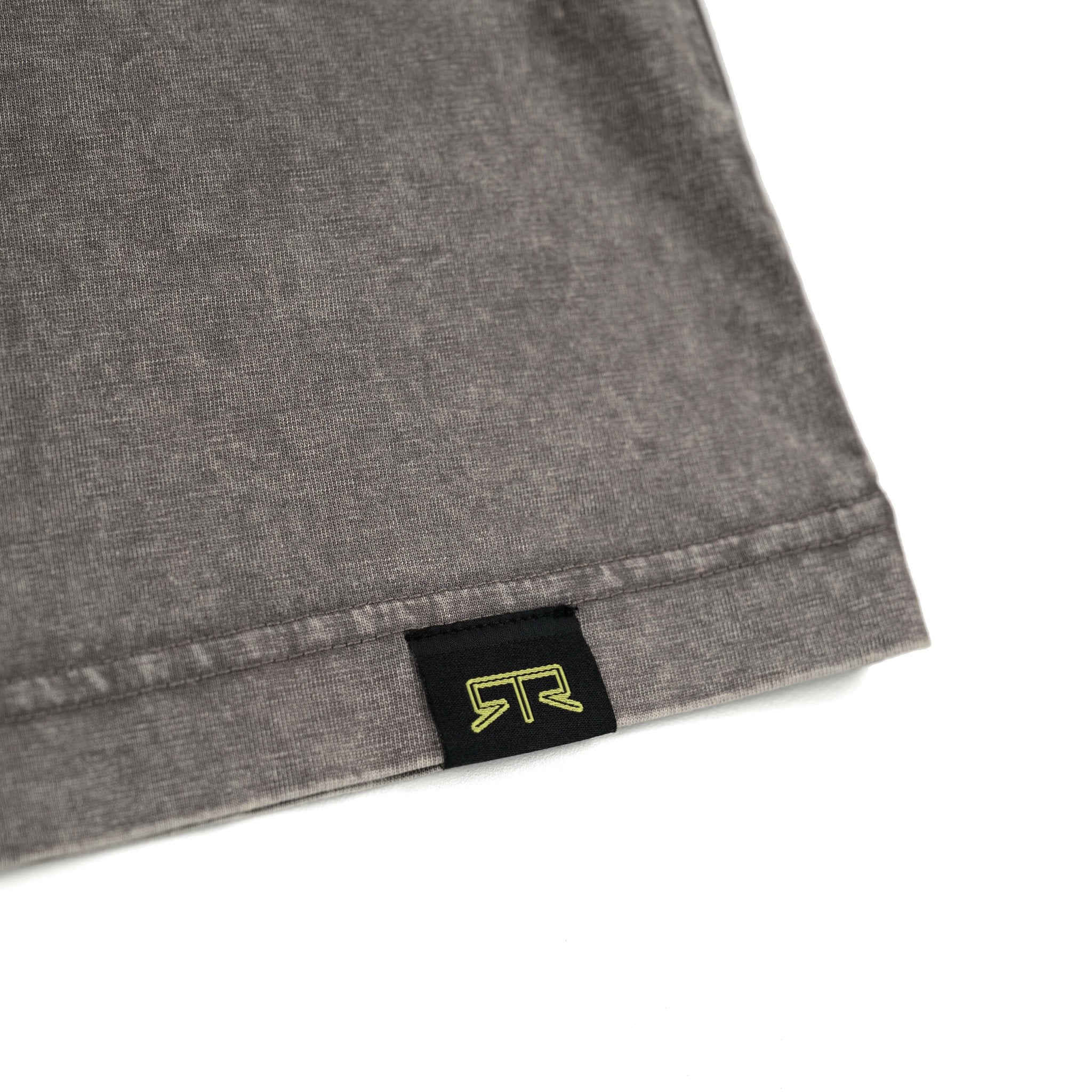 Close-up of RTR Tonal Logo T-Shirt's black and yellow label on grey fabric, showcasing the subtle tonal puff print logo and Ready to Rock™ text.