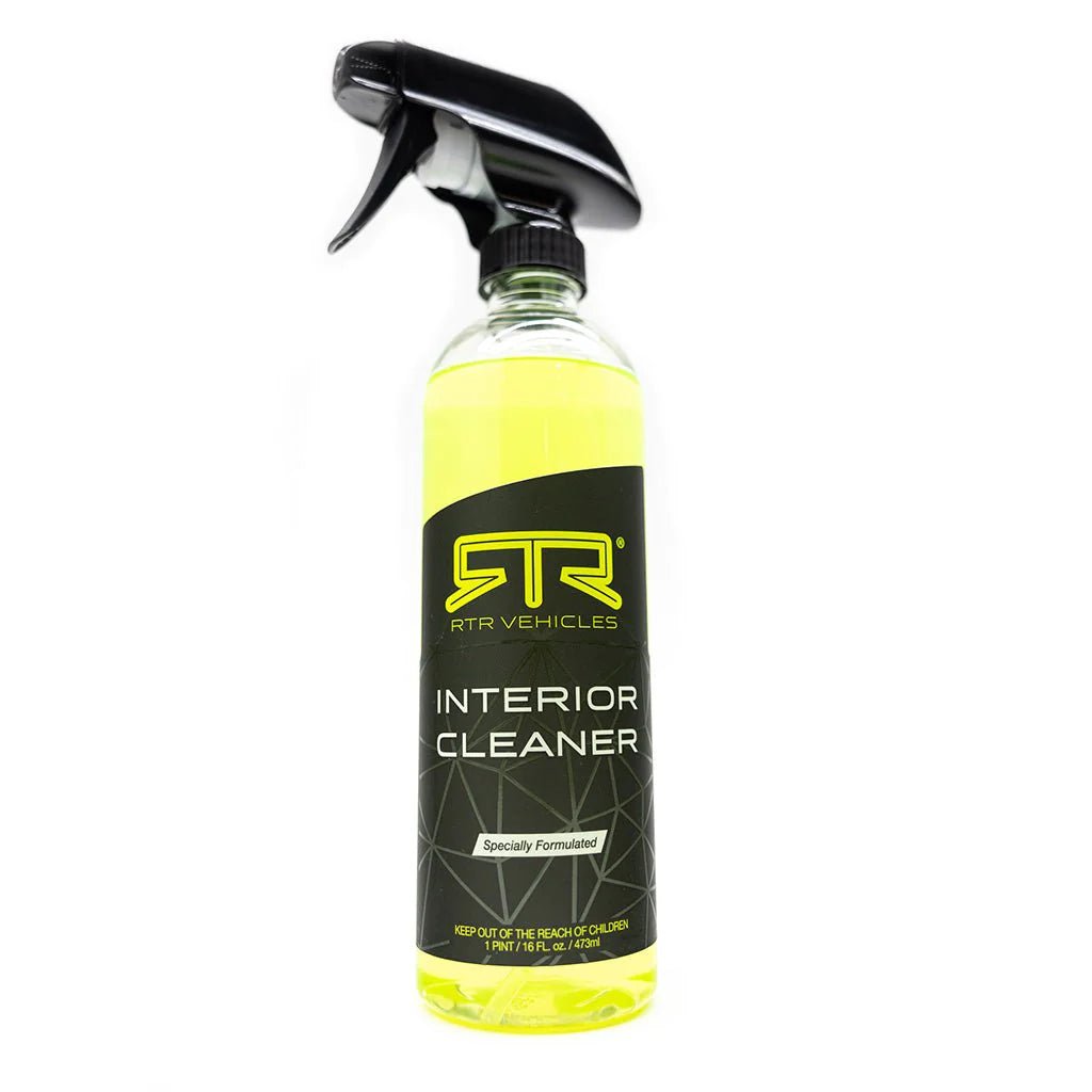 A close-up of RTR Interior Cleaner: a clear spray bottle with black label