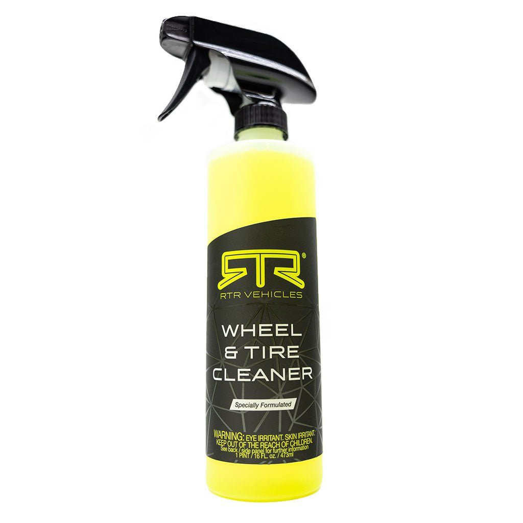 A close-up of RTR Wheel and Tire Cleaner: a yellow spray bottle with a black label, a black sprayer with a white nozzle, and a black and yellow label. Designed for easy vehicle cleaning without rinsing or scrubbing.