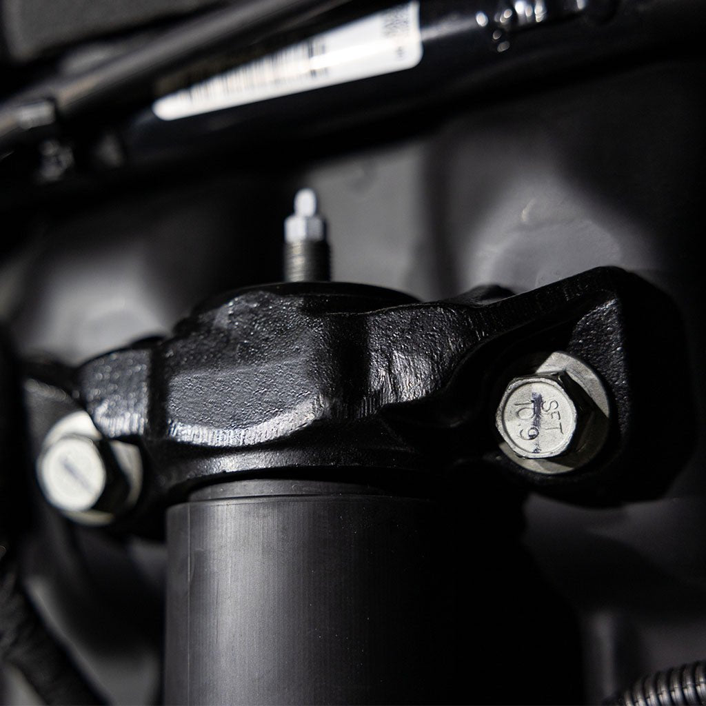 Close-up of RTR Rear Shock Mounts for 15+ Mustang, high-strength steel construction with bolts and nuts, designed for enhanced durability and precise fit.