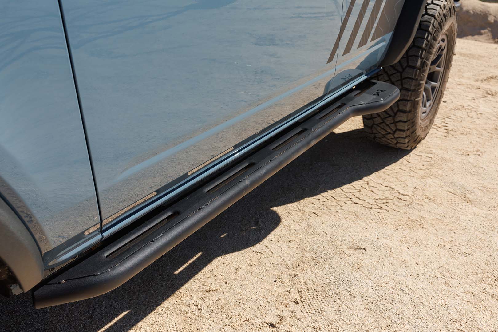 Bronco Trail Safe Package on a 21+ Bronco, showing a close-up of the side step and tire, highlighting the rugged and functional design for off-road use.