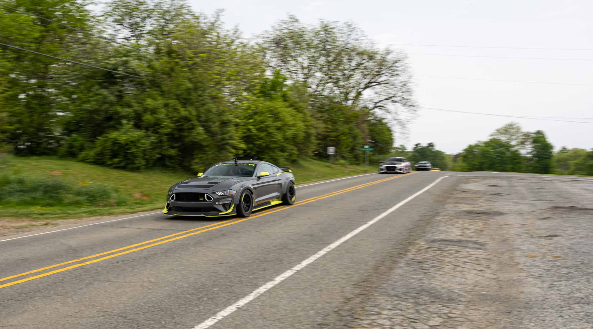A 10th anniversary edition Mustang RTR spec 5 cruises down a rural road