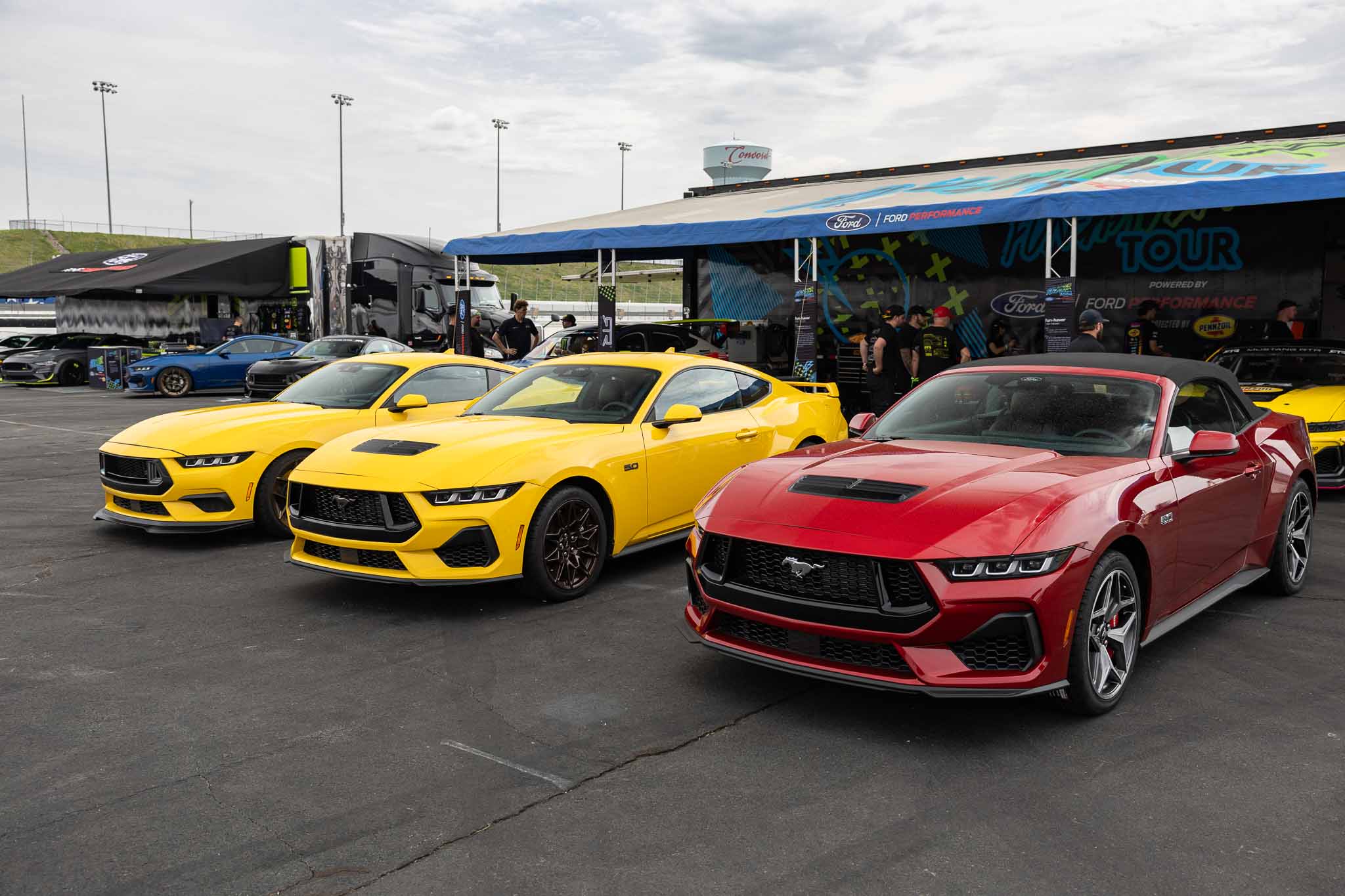 New 2024 Mustangs in front of the RTR booth at Charlotte Motor Speedway