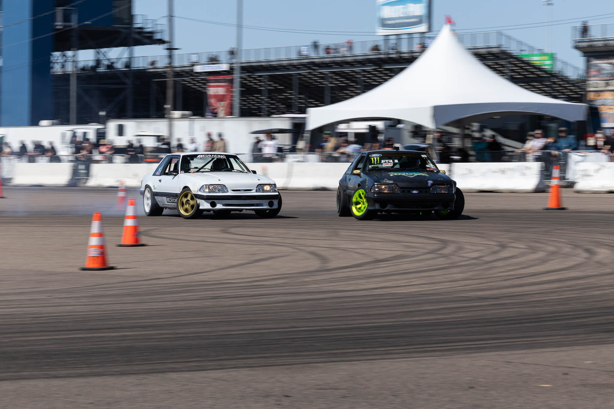 Vaughn Gittin Jr and Chelsea DeNofa drive their foxbody mustangs at Gainesville Raceway