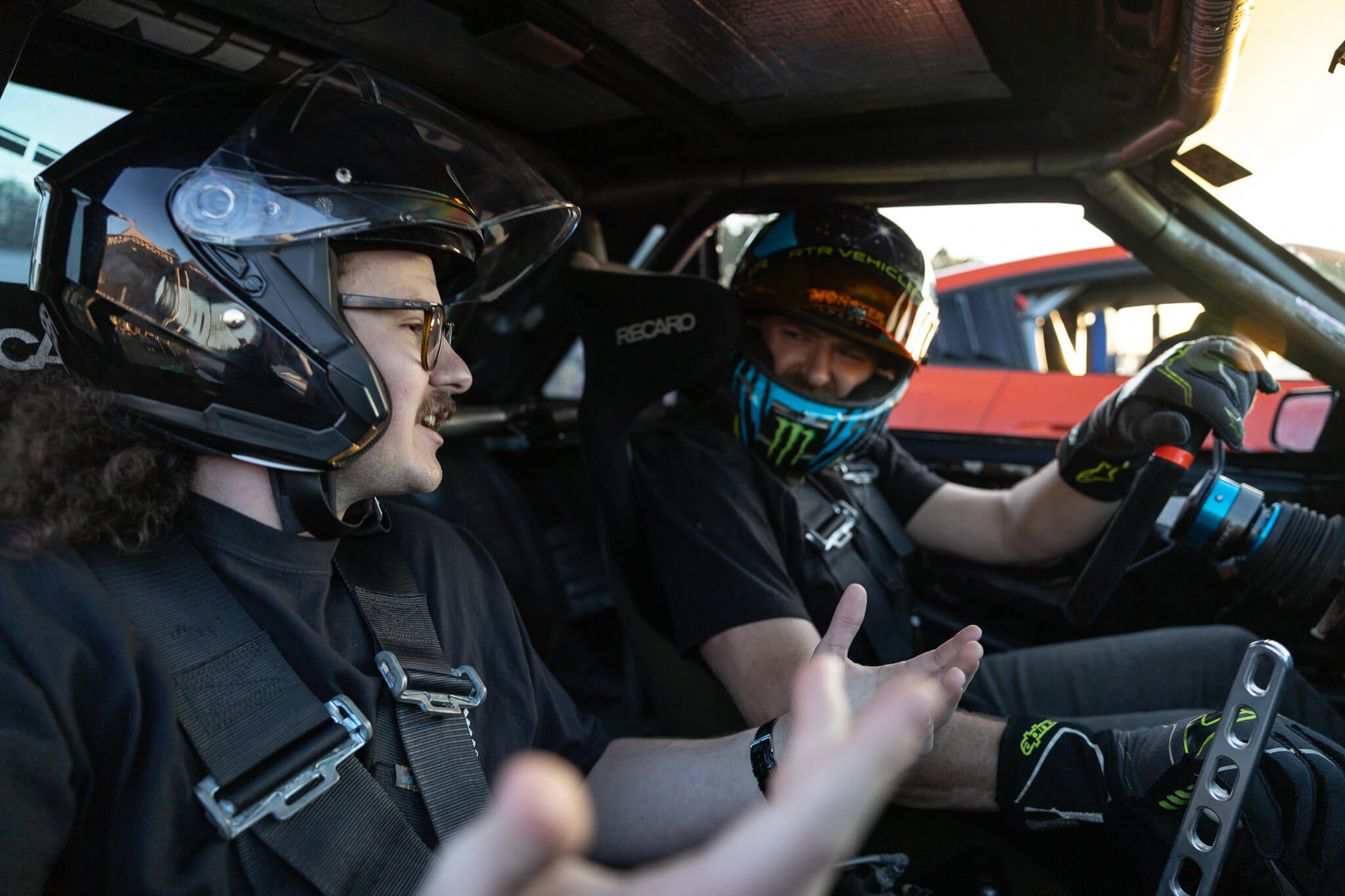 Vaughn Gittin Jr talks to a passenger prior to a ridealong in the foxbody