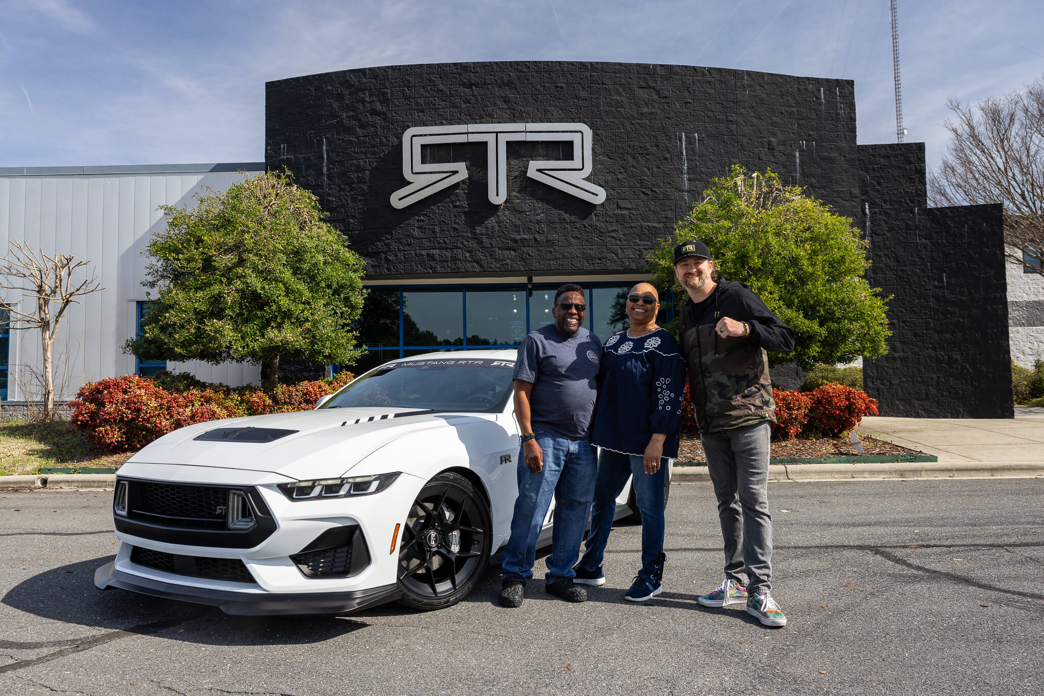 RTR owners take a picture with Vaughn at the RTR Lab with their 2024 Mustang RTR