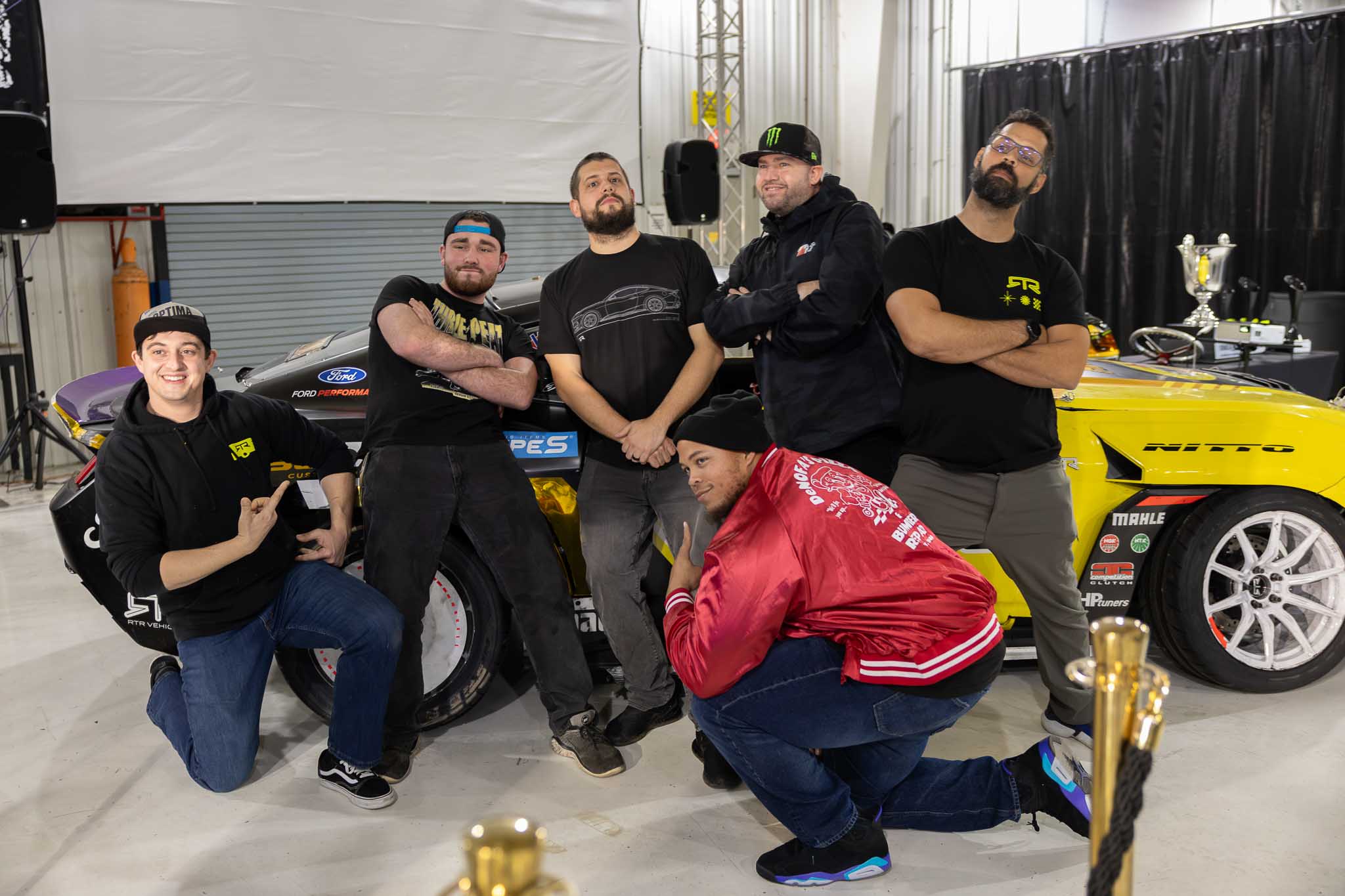RTR Team members pose for a picture in front of Chelsea's competition car.