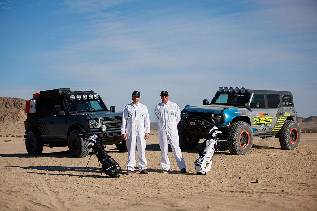 Vuaghn Gittin Jr. and Loren Healy in caddy uniforms in front of the Bronco RTR ROVR and Bronco FunRunner LT
