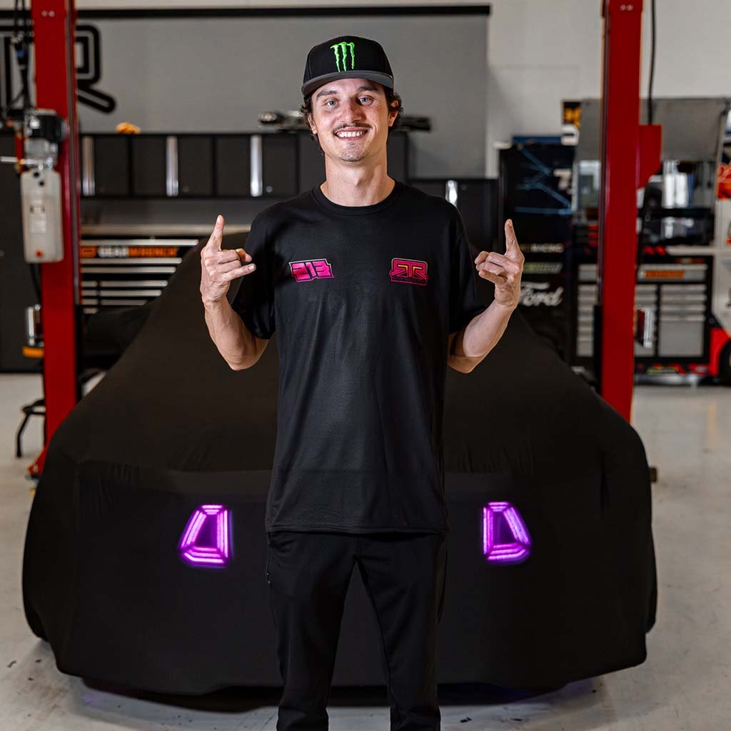 Ben Hobson in a black RTR shirt and Team hat, showcasing the Ben Hobson X RTR Tee, part of RTR Vehicles' Drift Team lineup.