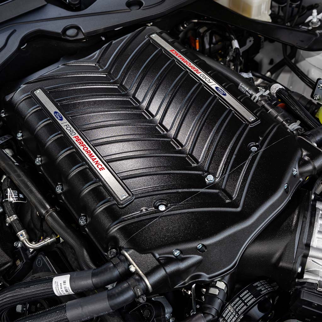 Ford Performance Supercharger Kit for 2024 Mustang GT, Dark Horse; close-up of engine components showcasing the advanced supercharger system's intricate design and power-enhancing features.