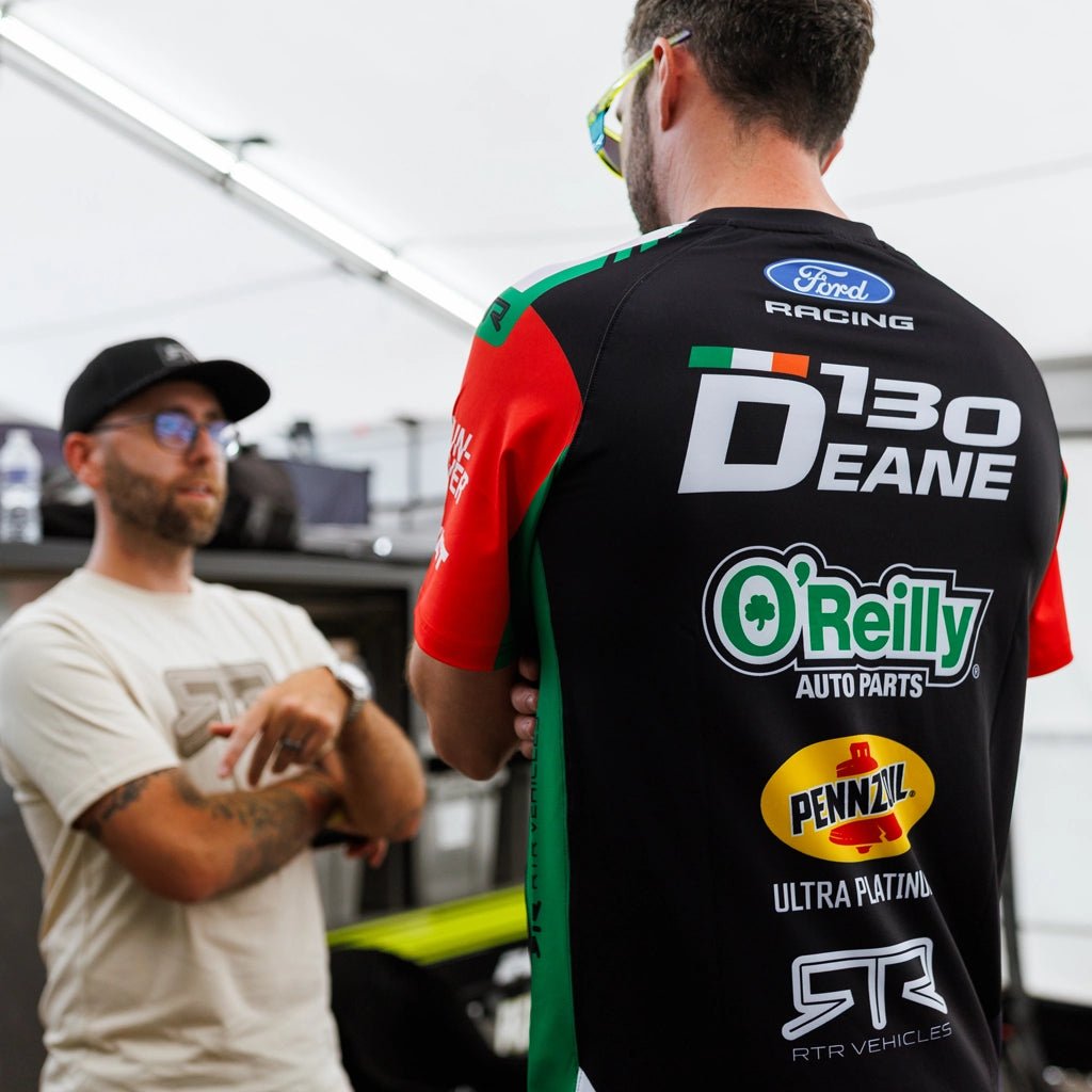 Back view of James Deane wearing his 2026 RTR Drift Team Sublimated Shirt at a Formula Drift event.