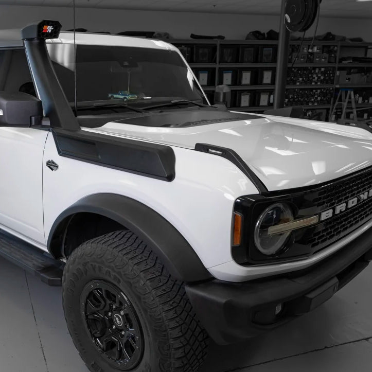 White SUV with black accents in a showroom setting