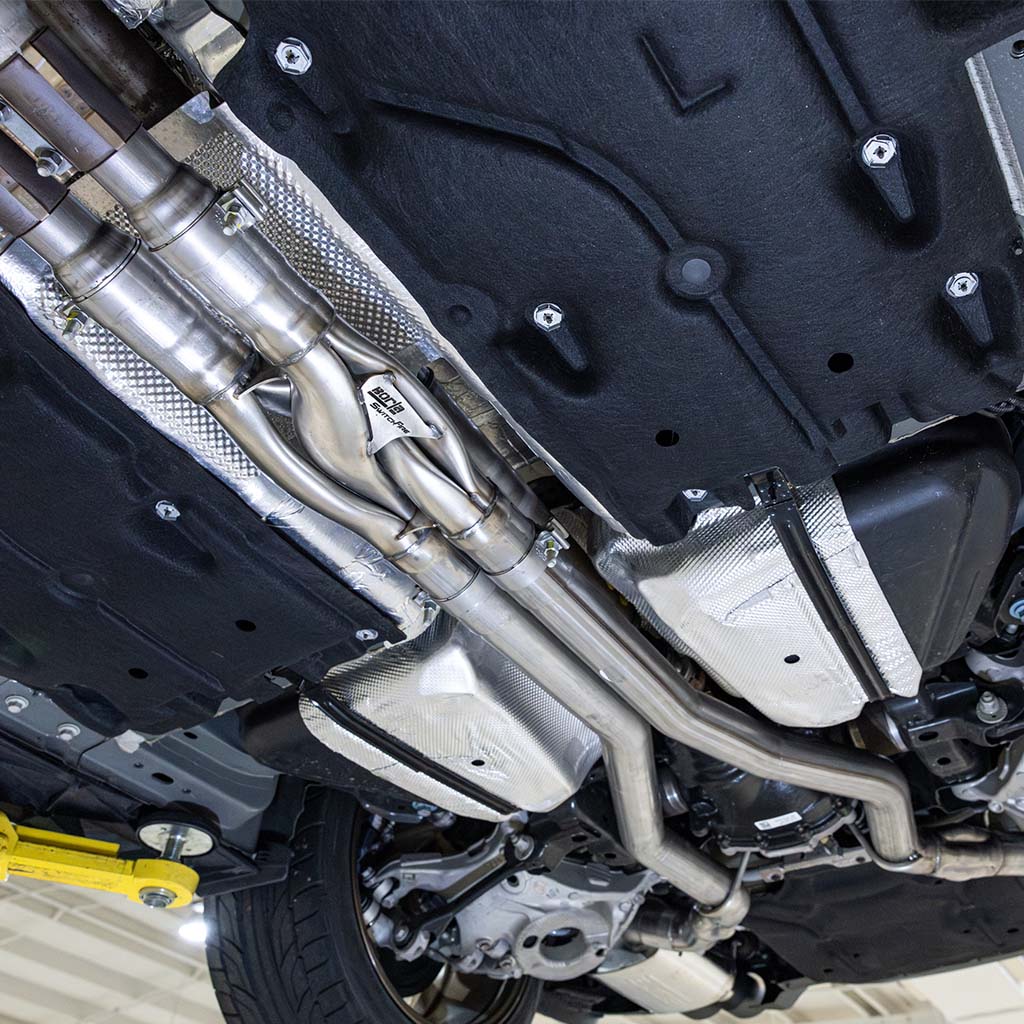 Close up of the RTR Active Cat-Back exhaust system mounted on a vehicle up on the lift.