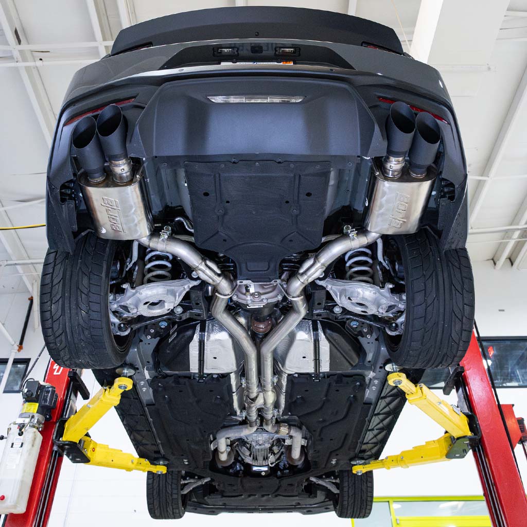 RTR Active Cat-Back exhaust system mounted on a vehicle up on the lift.