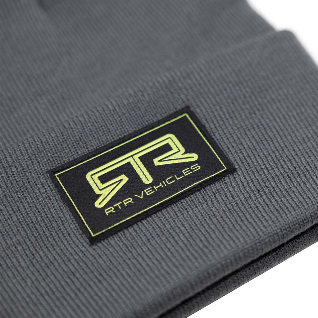 Close-up of the RTR Beanie featuring the black and Hyper Lime logo patch, highlighting the brand's identity and designed for comfort and style.