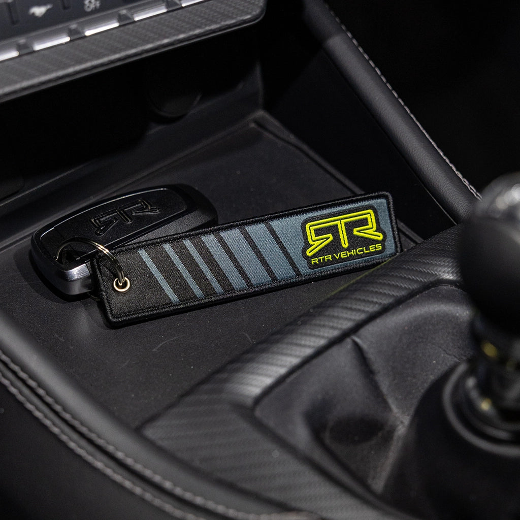 The RTR Core Flight Tag Keychain attached to an RTR key fob inside an RTR Ford Mustang.