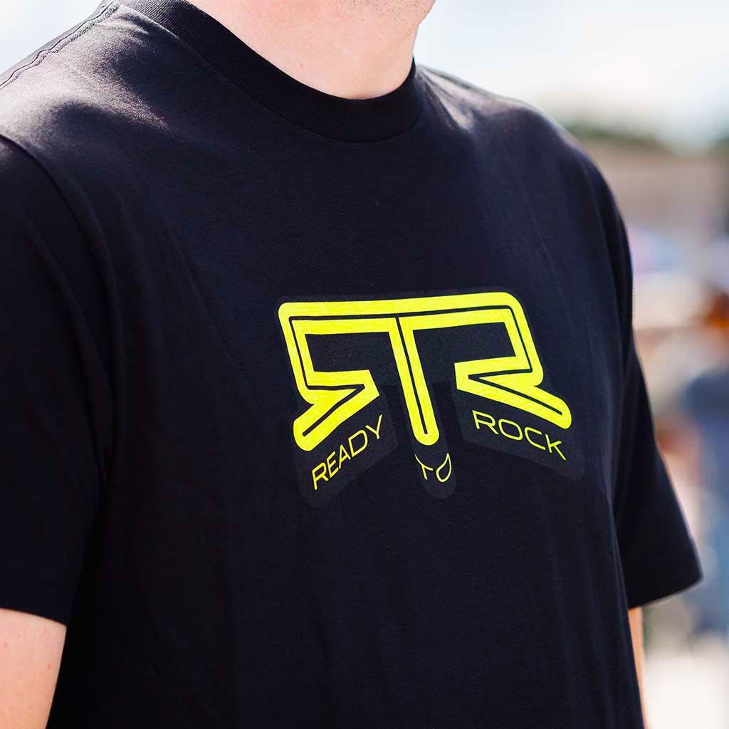 Close-up of the yellow RTR Ready to Rock graphic on the black RTR Core T-Shirt.