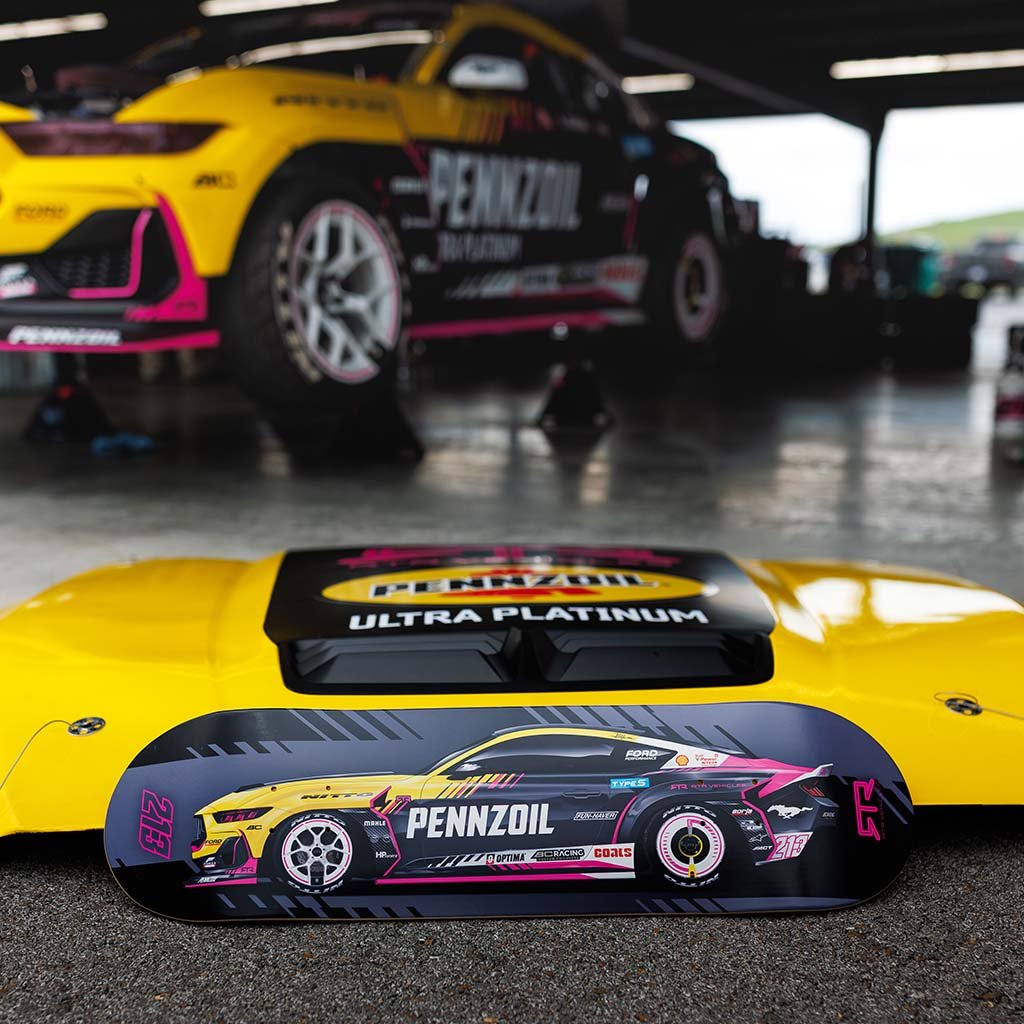 Ben Hobson's Mustang RTR Spec 5-FD with a skateboard featuring his 2025 livery design on a concrete floor.