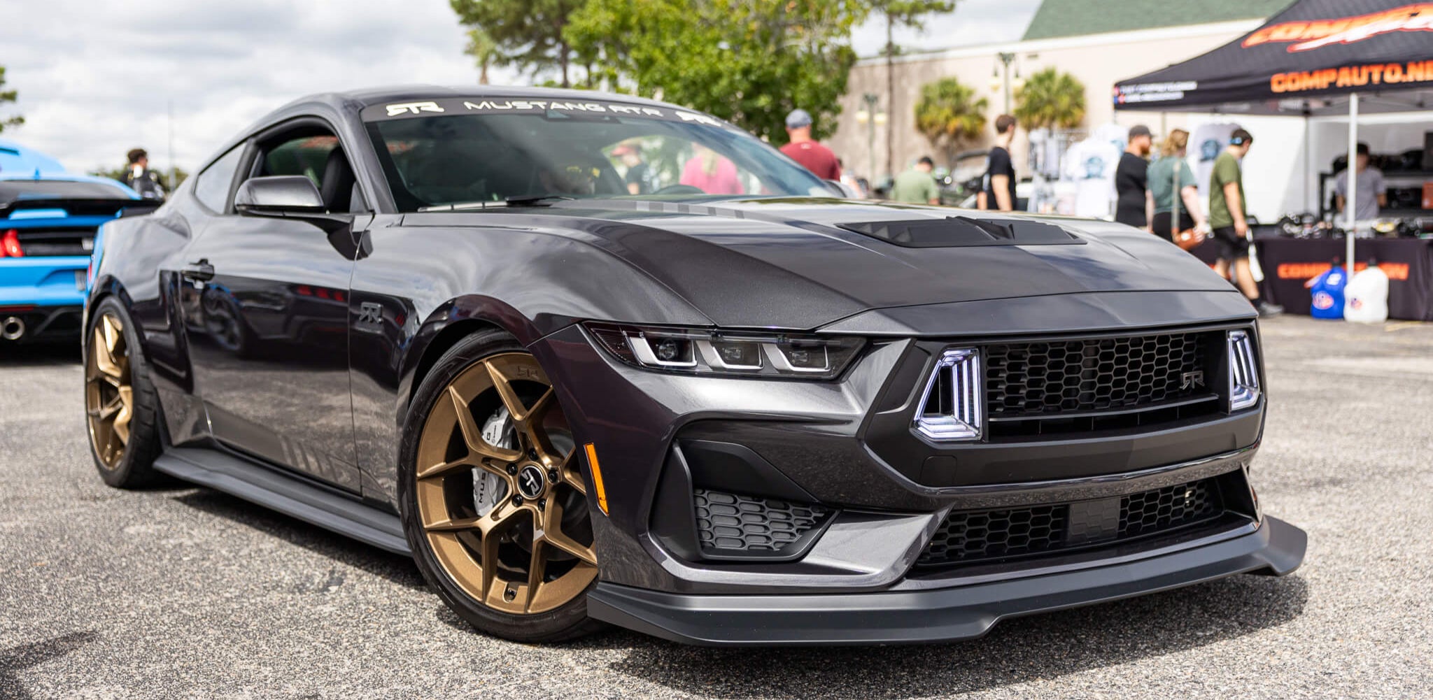 Black 2024 Mustang eqiuipped with RTR Lower Aero Package (24+ Mustang) featuring chin splitter, rocker splitters, and rear quarter splitters for enhanced aerodynamics and stability.