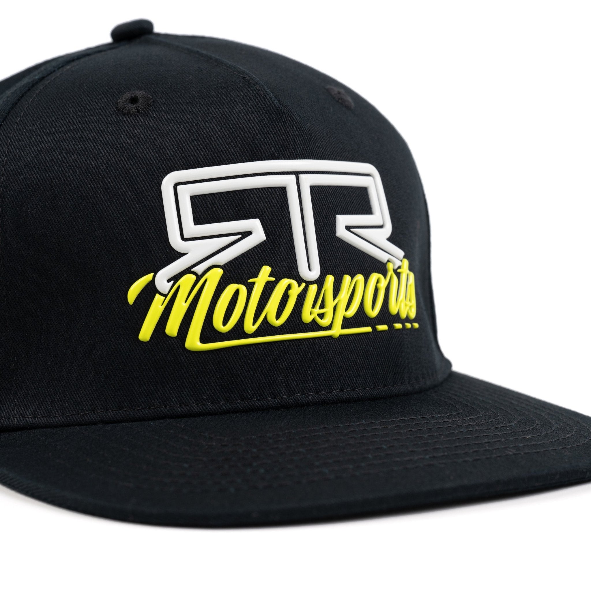 Close up of rubberized 'RTR Motorsports' logo on a black snapback cap against a white background