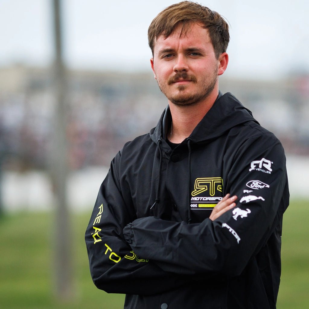 RTR Team crew member wearing the Black and Hyperlime RTR Motorsports Windbreaker Waterproof Jacket at Formula Drift.