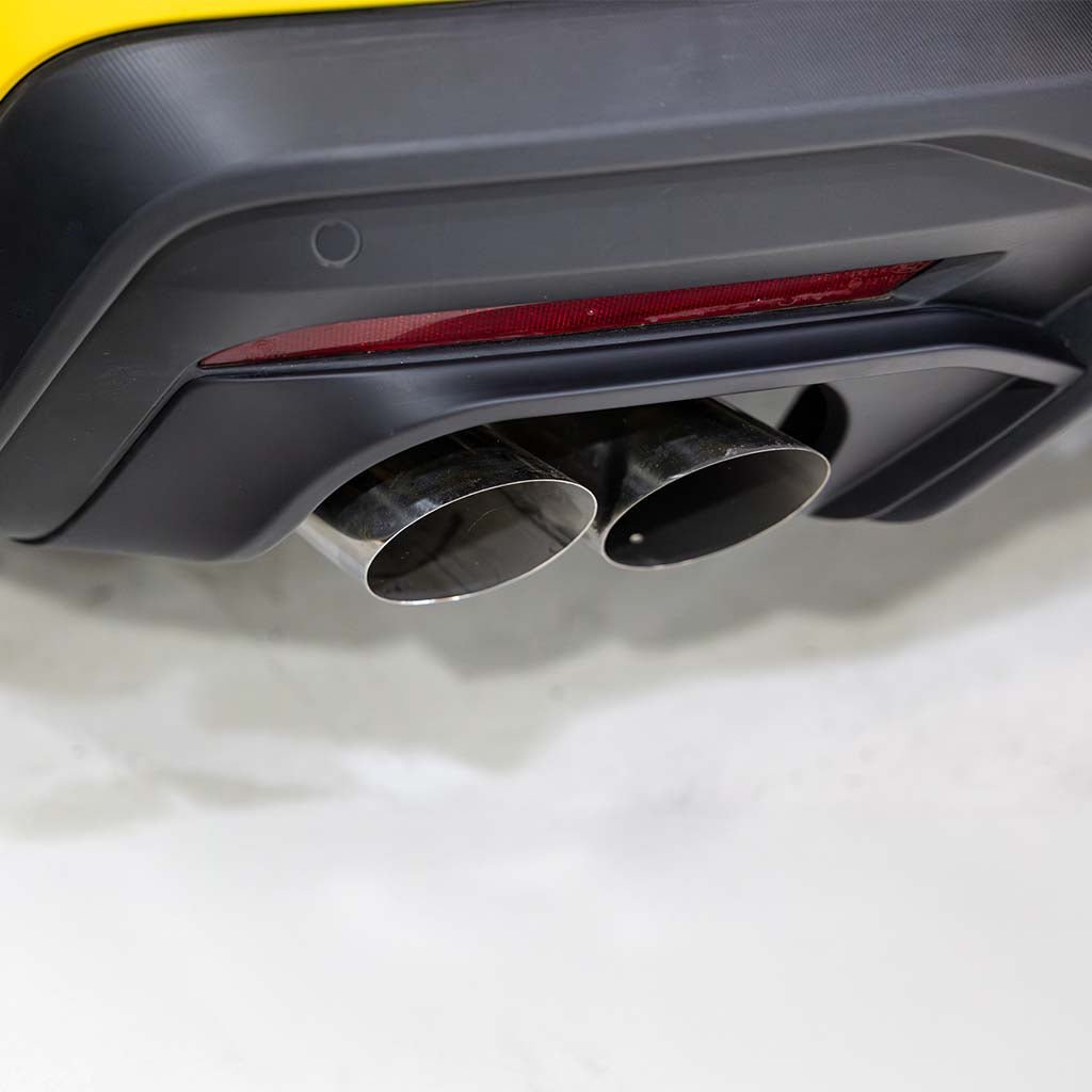 Close-up of RTR Quad Tip Exhaust Conversion Kit on 2024+ Mustang, featuring dual chrome exhaust tips in a black diffuser for an aggressive look.