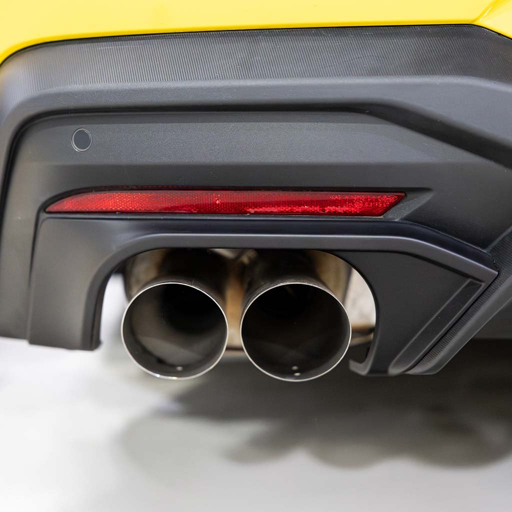 RTR Quad Tip Exhaust Conversion Kit for 2024+ Mustang shown with black diffuser, red reflector, and dual chrome exhaust outlets on yellow bumper.