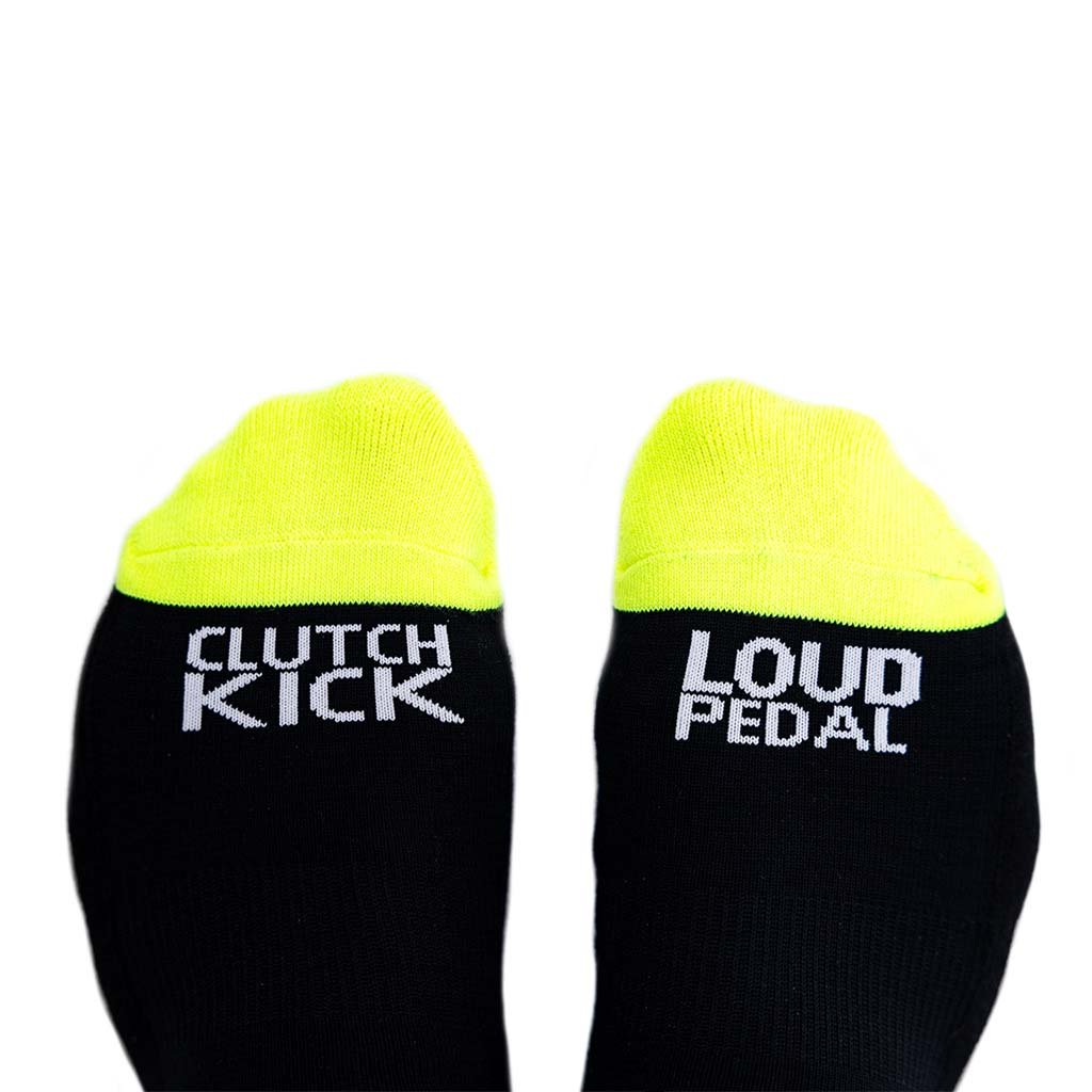 RTR Socks featuring bold black and hyper lime design with Clutch Kick and Loud Pedal text, offering style and comfort for any occasion.
