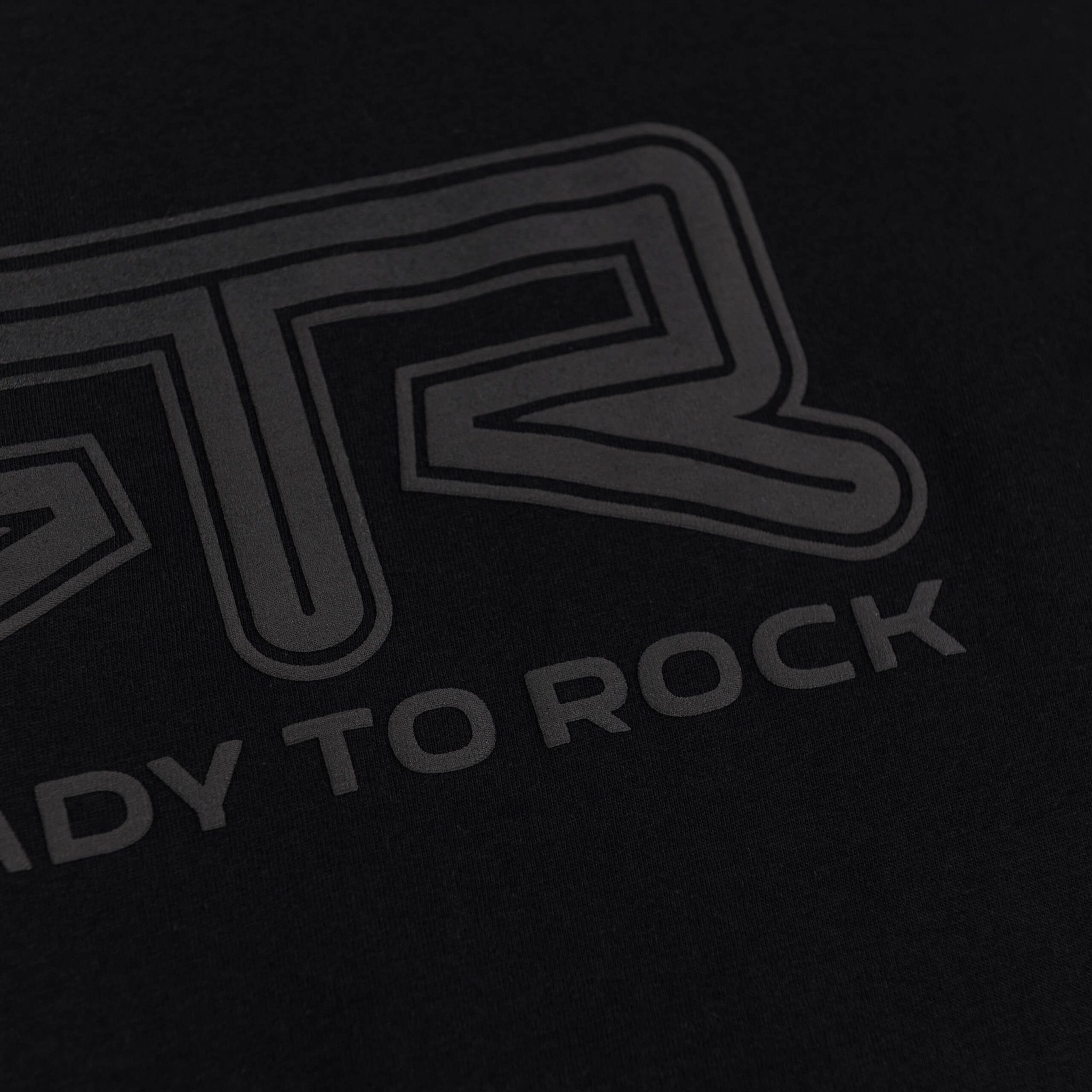 RTR Tonal Logo T-Shirt showcasing the Ready to Rock text in tonal puff print on black fabric, highlighting its minimalist and stylish design.